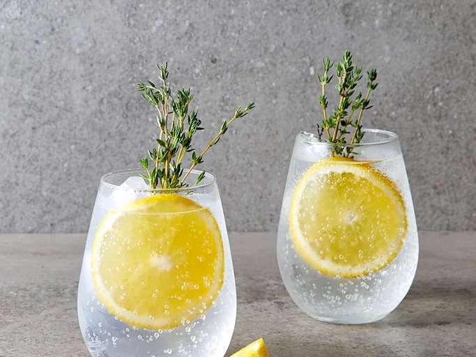 Two gin and tonics with lemon and thyme